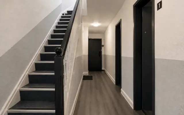 Cleaner mopping a shared stairwell in an HMO building